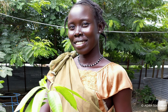 Nyanene P. aus Südsudan lächelt sehr liebevoll in die Kamera.