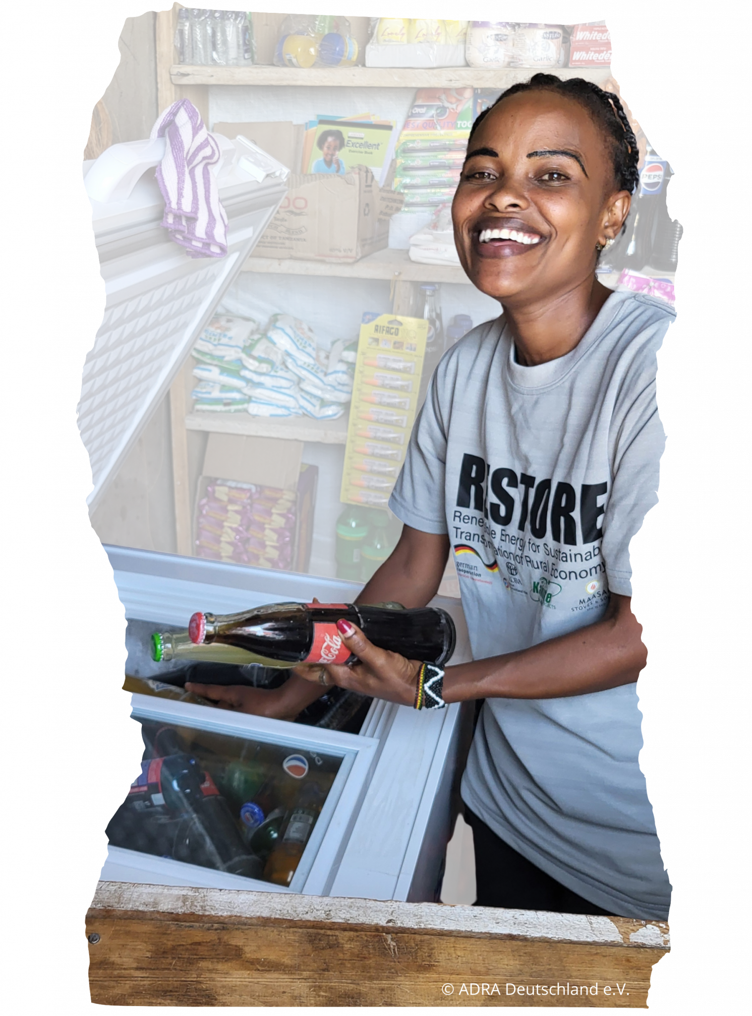 Eine Unternehmerin in ihrem Laden in Tansania mit solarbetriebenem Kühlschrank aus einem ADRA Projekt der Entwicklungszusammenarbeit