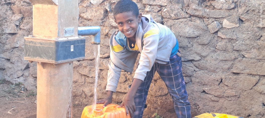 Junge aus Tigray füllt Kanister mit sauberem Wasser aus Pumpe – ADRA-Projekt verbessert Wasserversorgung und Perspektiven nach dem Krieg